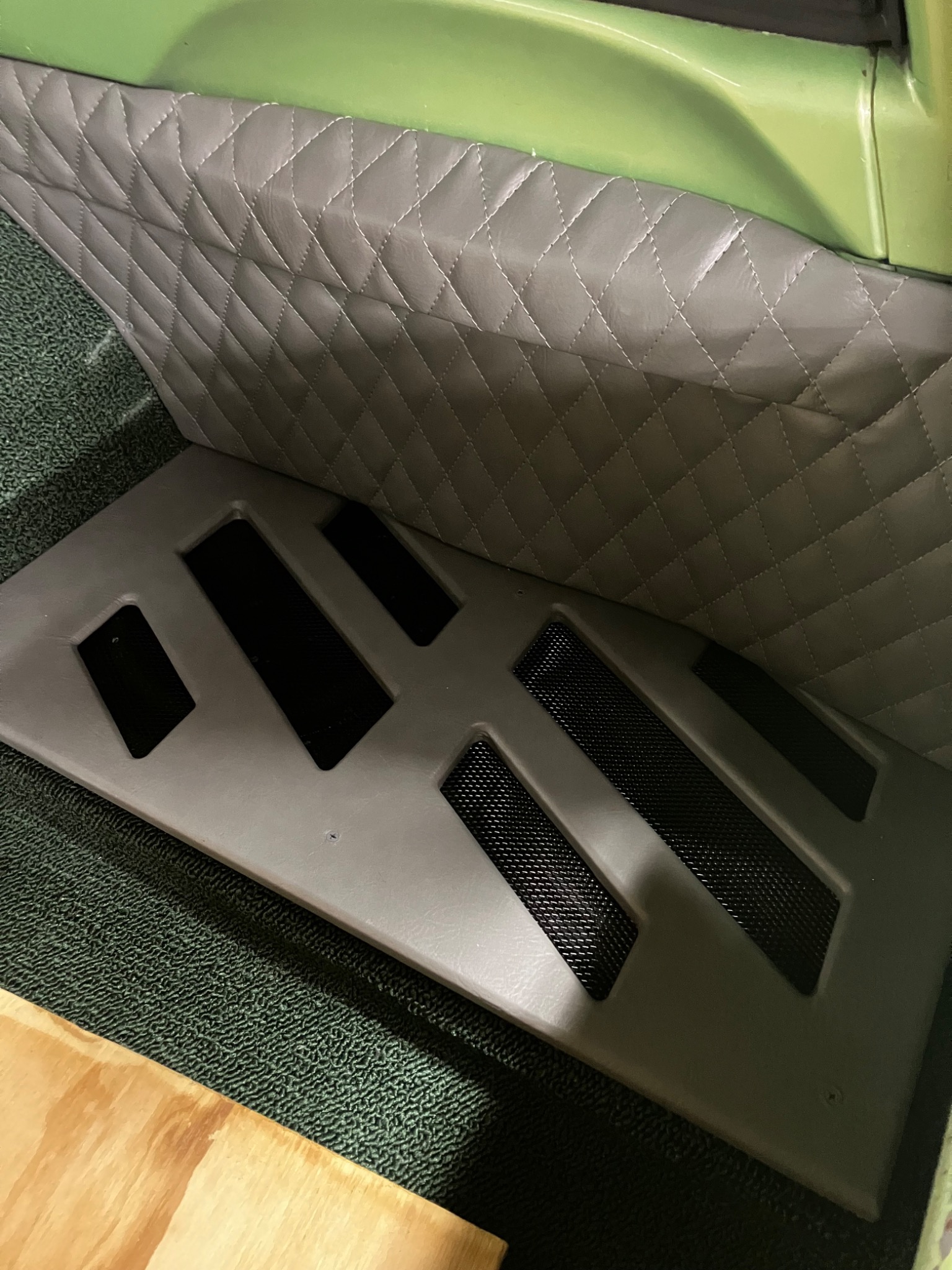 Custom speaker panel with diamond-stitched upholstery